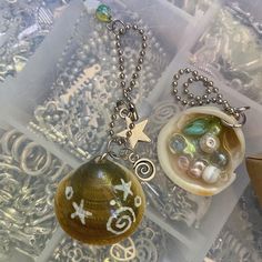 two necklaces that have been placed on top of each other, one with a star and the other with shells in it