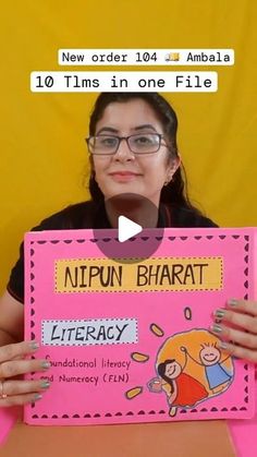 a woman holding up a pink sign that says nippun bhatt library