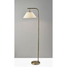 a floor lamp with a white shade on it's head and a metal base