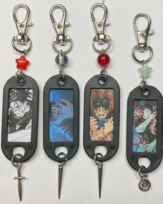 four different key chains with anime pictures on them