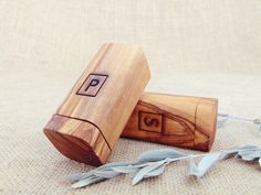 two wooden boxes sitting next to each other on top of a cloth covered tablecloth