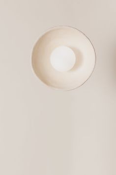 an overhead view of a light fixture in a room with white walls and flooring