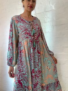 "This is beautiful light silky tunic dress with floral print in delicate blue and pink colours true boho chic style it is made loose and flared with high waist and long puff sleeve effortles to wear and easy fitting to all shapes perfect outfit for many occasions parties dinners birthday Christmas 😊 MEAESURE size M/L shoulders 18\" bust up to 40\" ( it is front tie srap, so can be easyli loosen up or tighten ) high waist 38\" length 45 \" MATERIAL *polisilk Thank You for looking" Long Spring Dresses With Boho Print, Long Boho Print Dresses For Spring, Spring Long Sleeve Viscose Dresses, Patterned Flowy Midi Dress With Long Sleeves, Patterned Boho Dress With Long Sleeves, Spring Boho Tunic Dress For Beach, Spring Boho Dress With Long Sleeves, Bohemian Flowy Tunic For Spring, Casual Viscose Tunic Dress