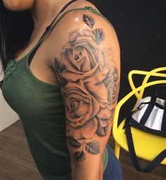 a woman with a rose tattoo on her arm