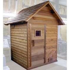 a small wooden shed with a metal roof