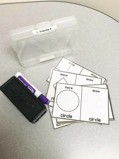 three pieces of paper sitting on top of a table next to a stamp pad and marker