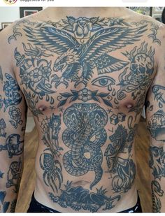 a man with tattoos on his chest and arms