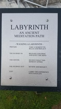 a sign in front of a building that says labyrrinth an ancient meditation path