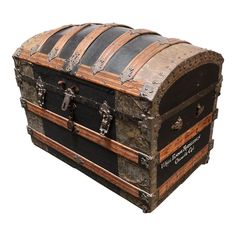 an old fashioned chest with metal and wood trimmings on the top, sitting upright