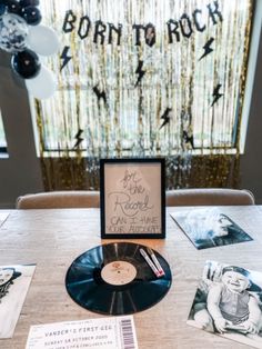 a table topped with black and white photos and an album on top of the table