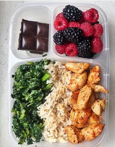 a plastic container filled with rice, fruit and meat