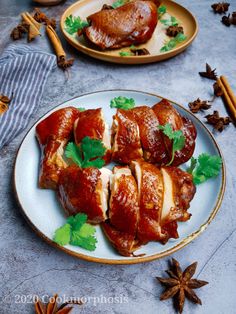 two plates with meat wrapped in sauce and garnished with parsley on the side