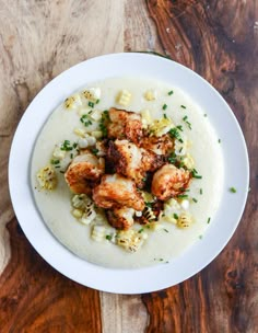 a white plate topped with food on top of a wooden table