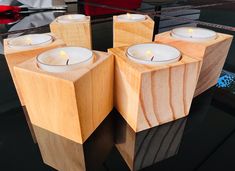 four wooden candles are sitting on a table