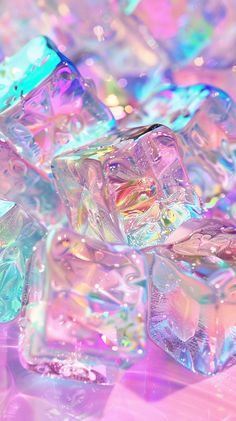 some ice cubes that are sitting on a table with pink and blue lights in the background