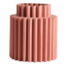 a tall pink vase sitting on top of a white table