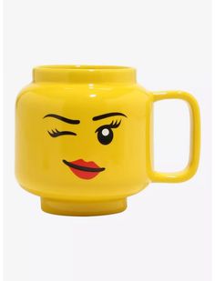 a yellow mug with a face painted on it