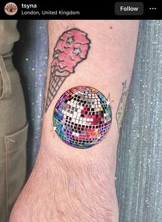 a person with a disco ball and ice cream cone on their arm that says, london, united kingdom follow