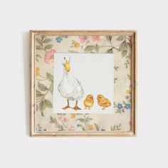 an image of a mother duck and her two chicks on a floral background with flowers