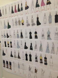 a wall with drawings of dresses on it and people standing in front of one another