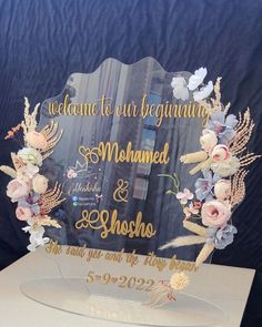 a clear acrylic sign with flowers on it