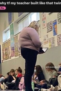 a woman standing in front of a classroom full of kids sitting on the floor and reading books