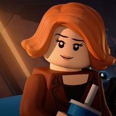 the lego movie character is holding a drink in her hand and looking at the camera