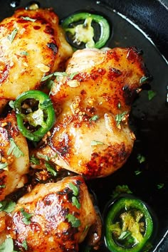 chicken and peppers in a skillet ready to be cooked with seasonings on the side