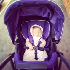 a baby is sitting in a stroller