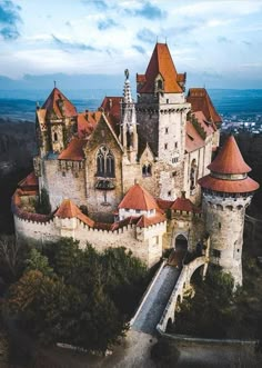 an aerial view of a castle with red roof tops