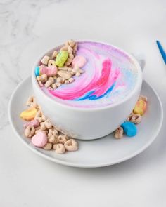 a white bowl filled with cereal and marshmallows on top of a plate