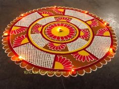 an intricately decorated table with lights on it and a candle in the shape of a flower