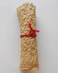 a piece of brown paper wrapped in red string