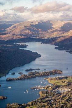 an aerial view of a lake surrounded by mountains