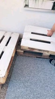 a person standing on top of a bed frame with their feet in the mattresses