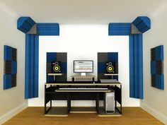 a computer desk sitting in front of two speakers and a keyboard on top of a hard wood floor