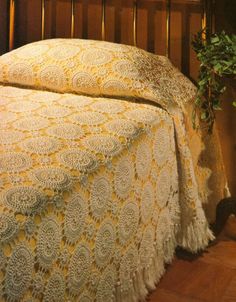 an image of a bed with yellow and white bedspread