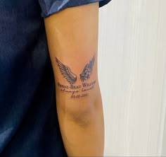 a man with a tattoo on his arm that has an eagle and the words brave, beautiful wings