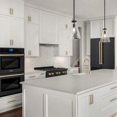 a kitchen with white cabinets, black appliances and marble counter tops is pictured in this image