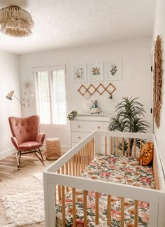 a baby's room with a crib, chair and dresser