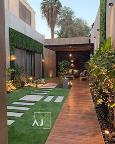 an outdoor living area with grass and lights