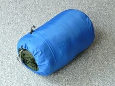 an open blue sleeping bag on the floor