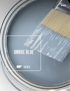 a paint can with a brush in it and the words ombre blue above it