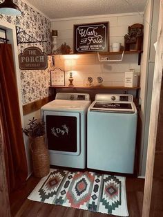 a washer and dryer in a small room with wood flooring on the walls