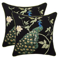 two black pillows with peacocks and flowers on them