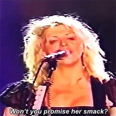 a woman singing into a microphone with the words, won't you promise her snack?