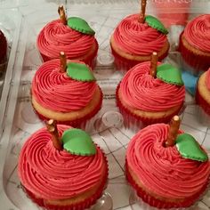 cupcakes with red frosting and green leaves on them