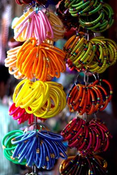 colorful bracelets are hanging from the ceiling