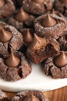 chocolate desserts are arranged on a white platter and ready to be cut into pieces