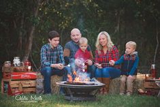 a family sitting around an outdoor fire pit